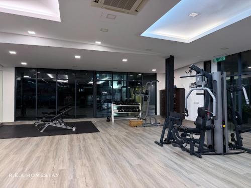 a gym with treadmills and machines in a room at Vivacity Jazz Suites Kuching by REA Homestay in Kuching