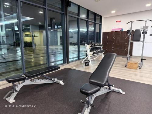 a gym with two exercise bikes in a room with windows at Vivacity Jazz Suites Kuching by REA Homestay in Kuching