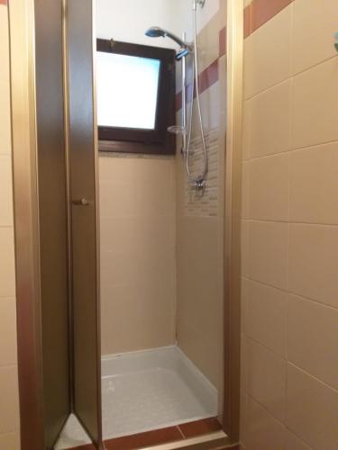 a shower in a bathroom with a window at La Casa sul Lago in Angera