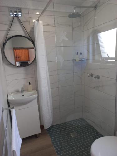 a bathroom with a shower and a sink at Rosa Villa in Hermanus