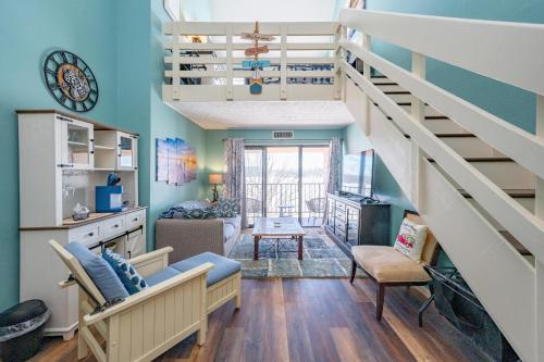 a living room with blue walls and a staircase at 710H Studio Loft One Bath in Oakland