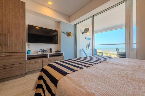 a bedroom with a large bed and a large window at Cartagena Beach Resort 807 in Cartagena de Indias
