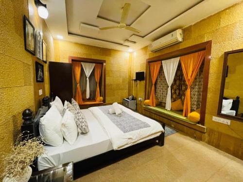 a bedroom with a bed and a ceiling at Hotel Meerana in Jaisalmer