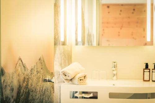 a bathroom with a sink and a mirror at Posthotel Lechtal, Arlberg in Holzgau
