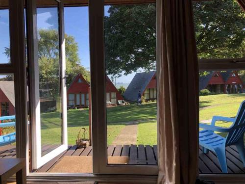 an open window with a view of a yard at Chalet 68 in Kingsdown