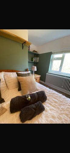 a stuffed animal laying on a bed in a bedroom at Chestnut Cottage in Great Ellingham