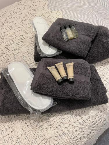 a table with two towels and candles on a table at Chestnut Cottage in Great Ellingham