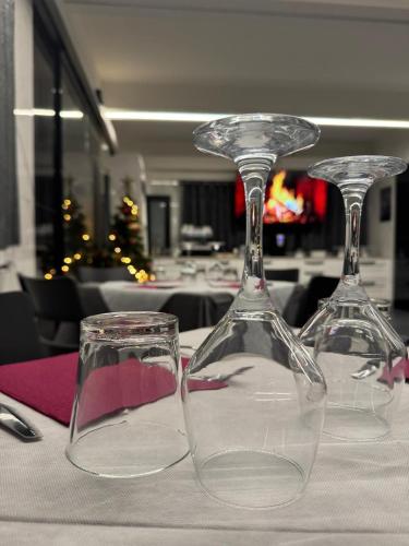 two empty wine glasses sitting on a table at Hotel La Torre in Formigine