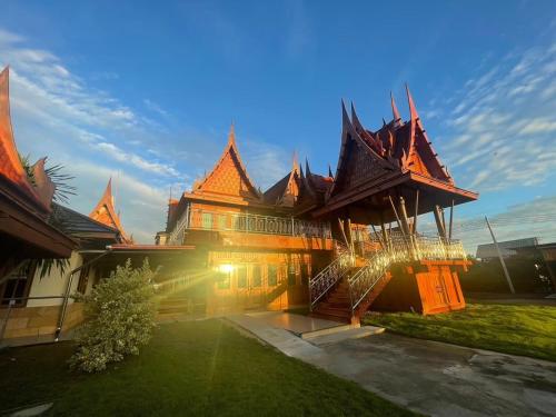ein großes Gebäude mit einem Hof davor in der Unterkunft Ruen Singhanat Cafe & Resort in Ban Lum Thonglang (2)