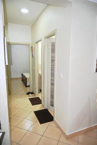 a hallway with white walls and a tiled floor at Hogar Feliz - apartment in Agadir