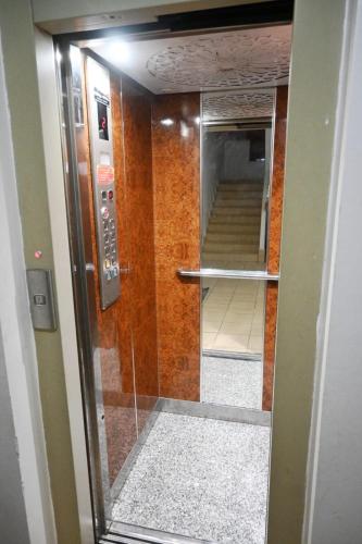 a glass door leading to a hallway with a staircase at Hogar Feliz - apartment in Agadir