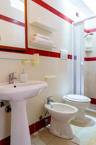 a bathroom with a sink and a toilet at Residence Atenaion in Otranto