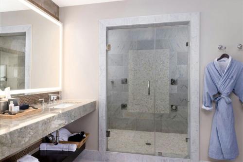 a bathroom with a shower and a sink at The Stella Hotel, Autograph Collection in Bryan