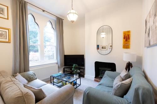 a living room with two couches and a fireplace at HIGH SAINT COTTAGE - Stunning 3 Bed Accommodation located in Ripon, North Yorkshire in Ripon
