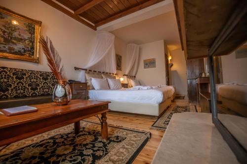a hotel room with a bed and a table and a desk at Archontiko Zakoni in Neochori