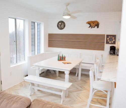 a white dining room with a white table and chairs at Eagles Mountain Retreat in Somerset