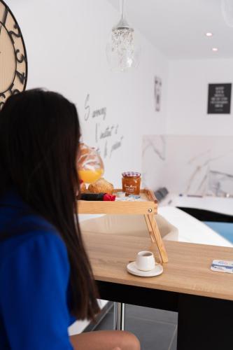 a woman sitting at a table with a tray of food at L'OLYMPE DES SENS in Portiragnes