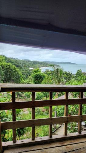 a view of the ocean from a wooden balcony at Sea Views bungalow kohrong in Koh Rong Island