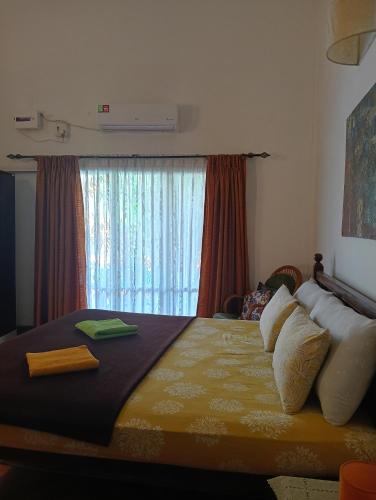 a bedroom with a large bed with a window at Jass luxury stays in Anjuna