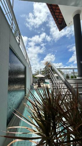 a swimming pool with a potted plant next to a building at Nautillus Hotel in Parnaíba