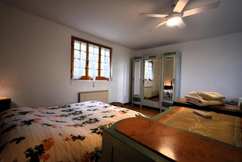 a bedroom with a bed and a ceiling fan at Villa Panorama Exclusive Pool in Loro Ciuffenna