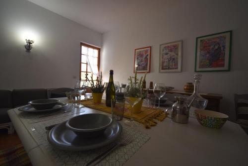 a dining room table with plates and wine glasses at Villa Panorama Exclusive Pool in Loro Ciuffenna
