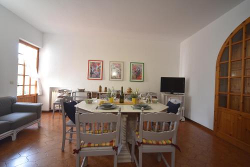 a dining room with a table and chairs at Villa Panorama Exclusive Pool in Loro Ciuffenna