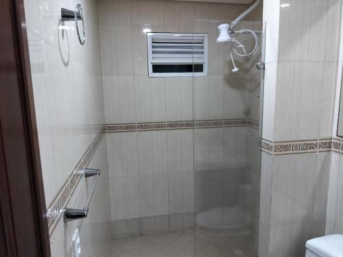 a bathroom with a shower with a glass door at Laguito Apartment in Cartagena de Indias