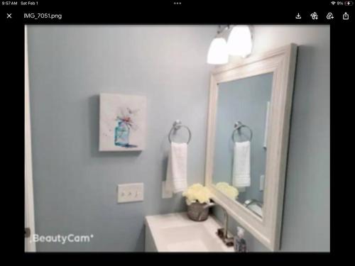 a bathroom with a sink and a mirror at Sweet little bedroom next fells point in Baltimore