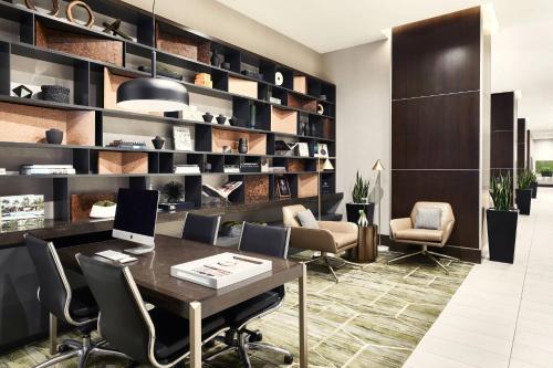a office with a desk with chairs and a laptop at AC Hotel by Marriott Beverly Hills in Los Angeles