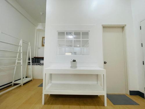 a white table in a room with a window at Villa Darroca Palawan in Araceli