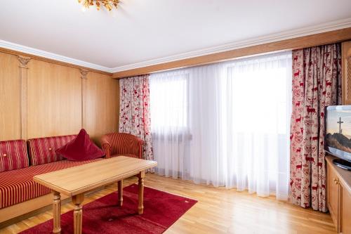 a living room with a couch and a table at Aparthotel Landhaus St. Joseph (Indoor Pool) in Mayrhofen