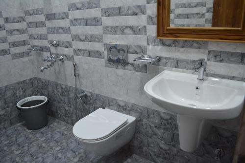 a bathroom with a toilet and a sink at Yanam resorts in Yanam