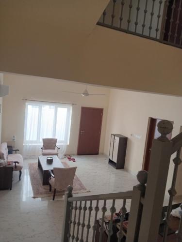 a living room with a couch and a table at Gisoo Guesthouse in Muscat