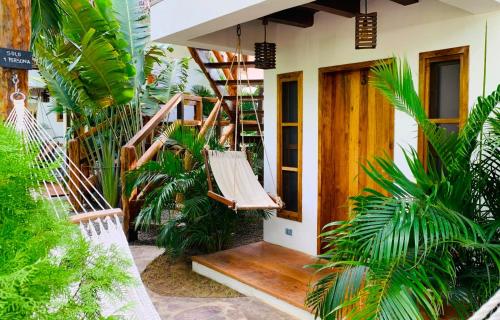 a porch of a house with a hammock on it at Casitas Pacific in Popoyo