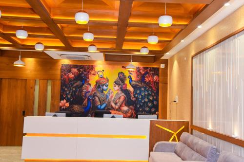 a lobby with a large painting on the wall at Dasara Executive in Tuljapur