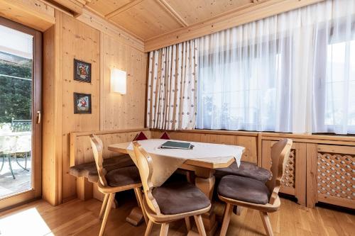 a dining room with a table and chairs at Aparthotel Landhaus St. Joseph (Indoor Pool) in Mayrhofen