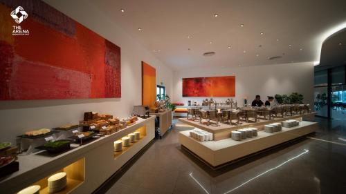 a restaurant with a bunch of food on display at Arena Cam Ranh Pearl Bay in Cam Ranh