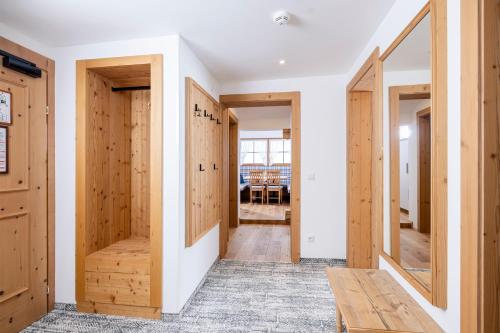 a hallway with wooden doors in a house at Aparthotel Landhaus St. Joseph (Indoor Pool) in Mayrhofen