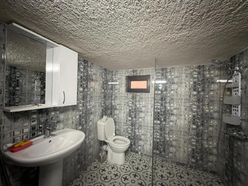a bathroom with a sink and a toilet at Family Holiday in K'obulet'i