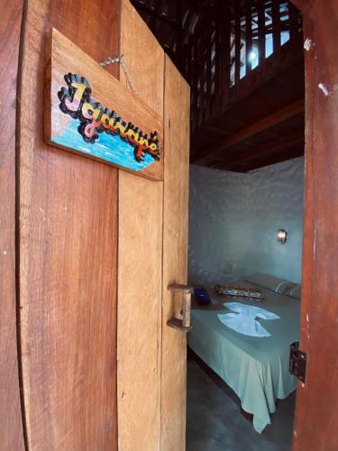 a door to a bedroom with a bed in it at Chalé Igarapé in Santarém