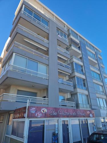 un grand bâtiment avec une enseigne devant dans l'établissement Appartement Front de mer CIMER, à Canet