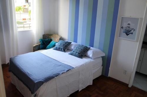 a bedroom with a bed with blue and white stripes at Apartment in Ondina, Carnival Circuit, Luxury in Salvador