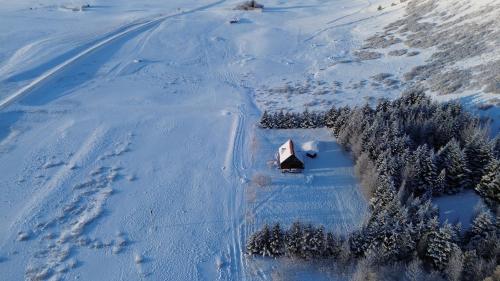 an aerial view of a cabin in the snow at Lodge Borgarbrekka in Lón South East of Iceland - Birta Rentals in Höfn