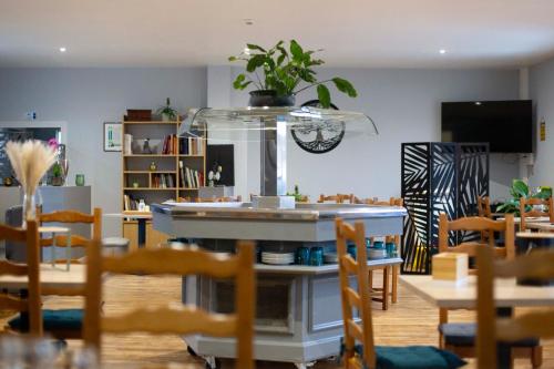 a dining room with chairs and a table with a counter at L Escale in Ports