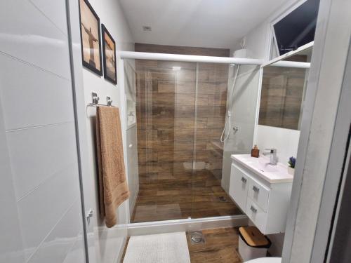 a bathroom with a shower and a toilet and a sink at Loft Copacabana Mar in Rio de Janeiro