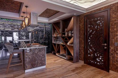 a wine tasting room with a bar and a wine cellar at Makanda by The Sea Hotel Adults Only in Manuel Antonio
