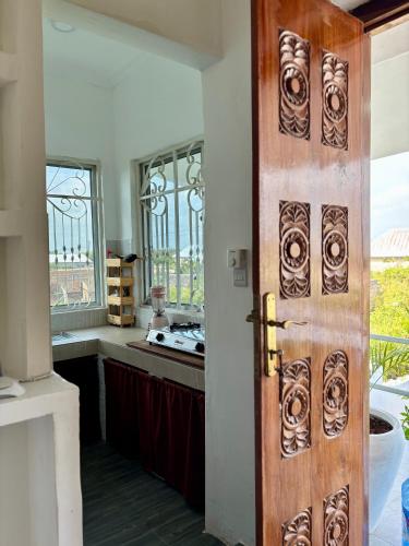 an open door to a kitchen with a sink at Samia House in Jambiani