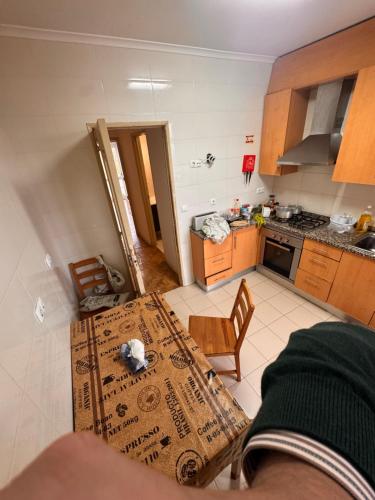 a view of a kitchen with a table and chairs at Center Rooms Alverca in Alverca