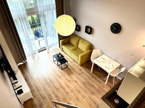 a living room with a couch and a table at Zarembowicza Apt 36 - Self Check-In 20h - Parking &Lift in Wrocław